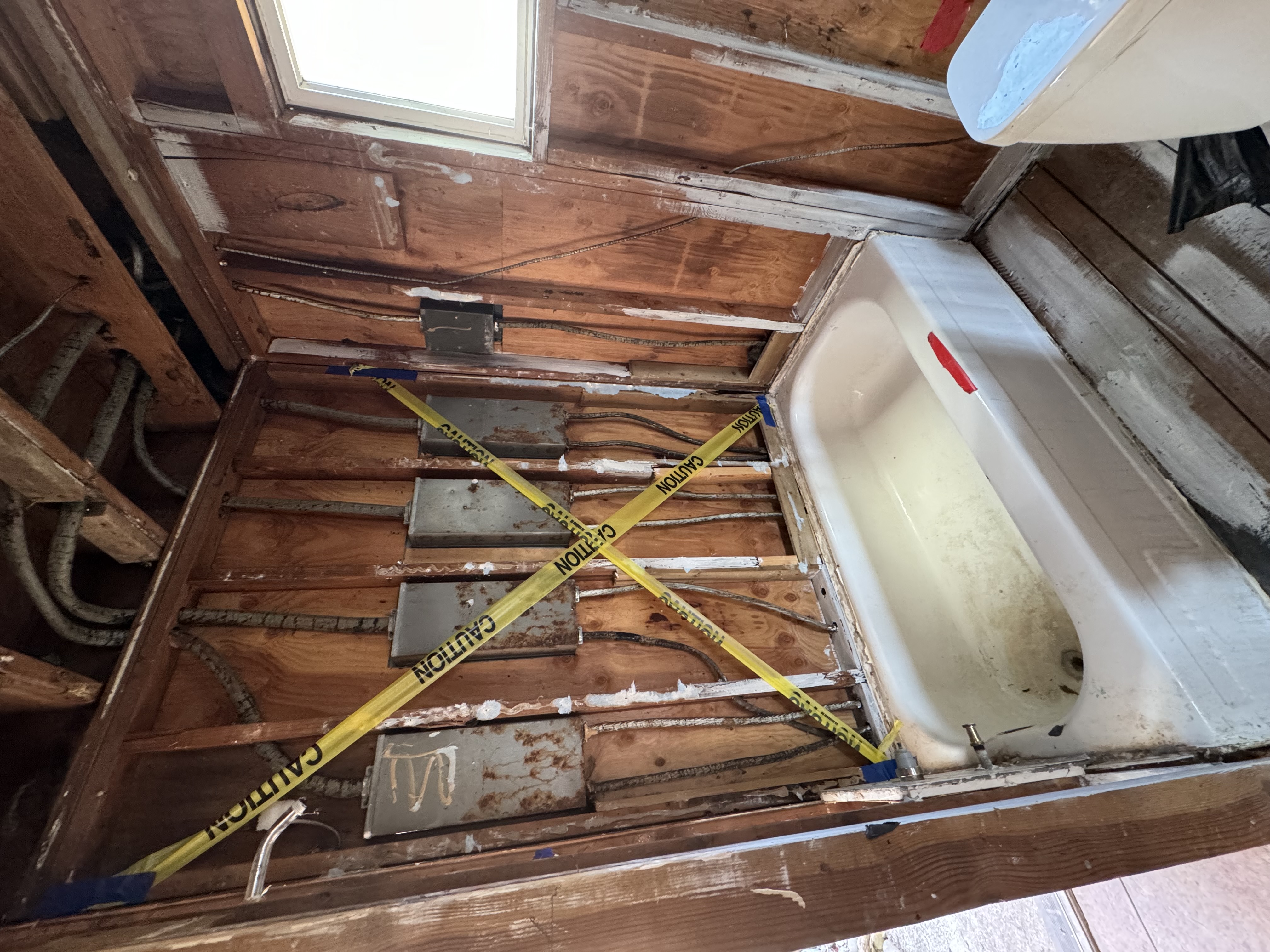 Bathroom mold damage with exposed wall studs