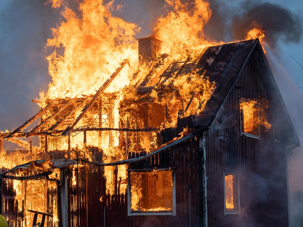 House engulfed in flames and smoke.